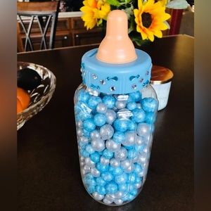 Giant baby bottle with blue & silver glitter balls. Baby shower guessing game.